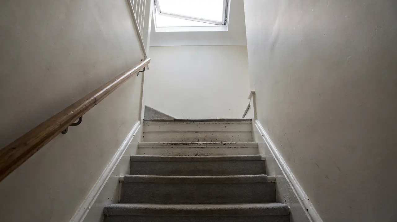 Stairwell lit by a flat rooflight at the top