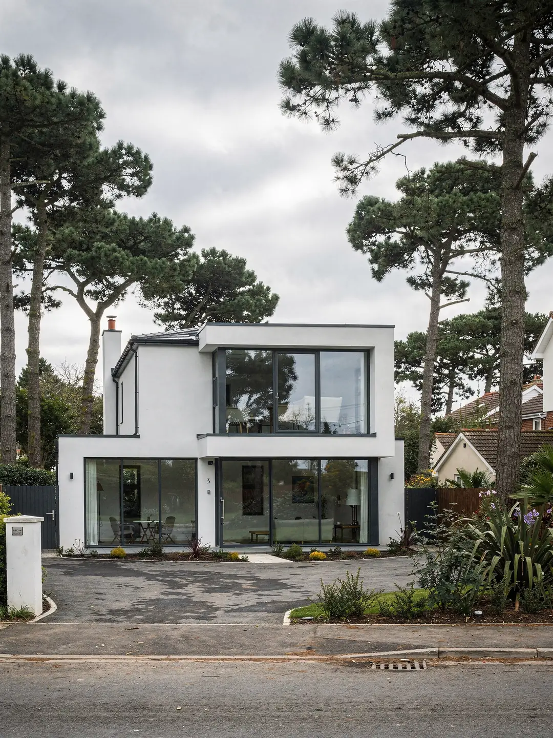 A contemporary house with a flat roof section and a large rooflight over the main living space